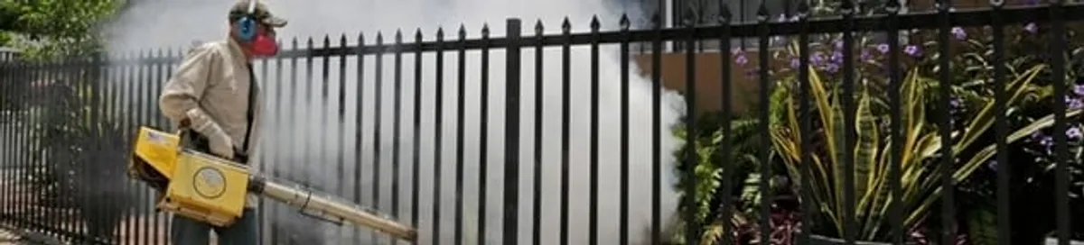 Mosquito control technician fogging a yard perimeter for mosquito reduction in Atlanta, GA